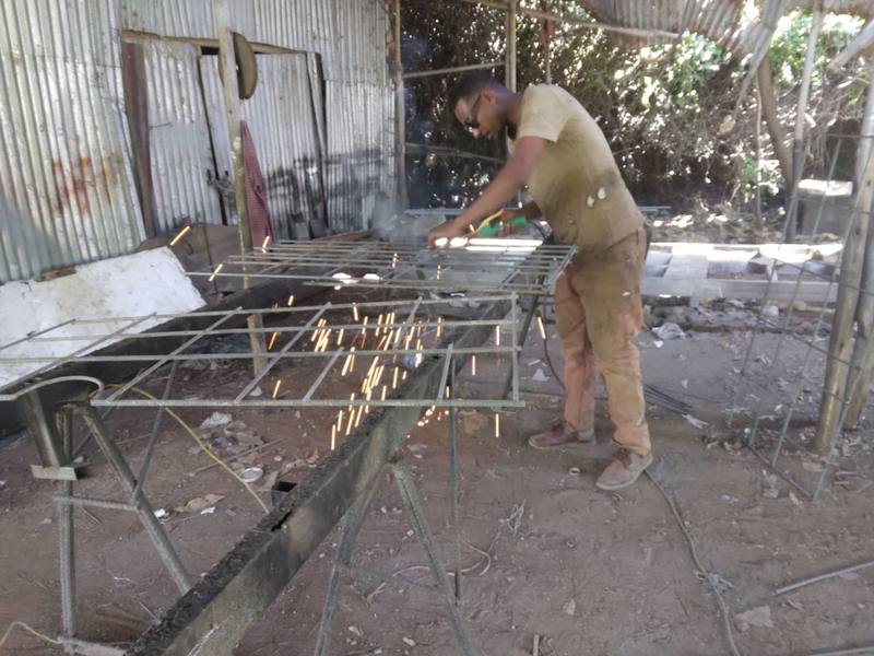 A fabricator welding a steel production mold